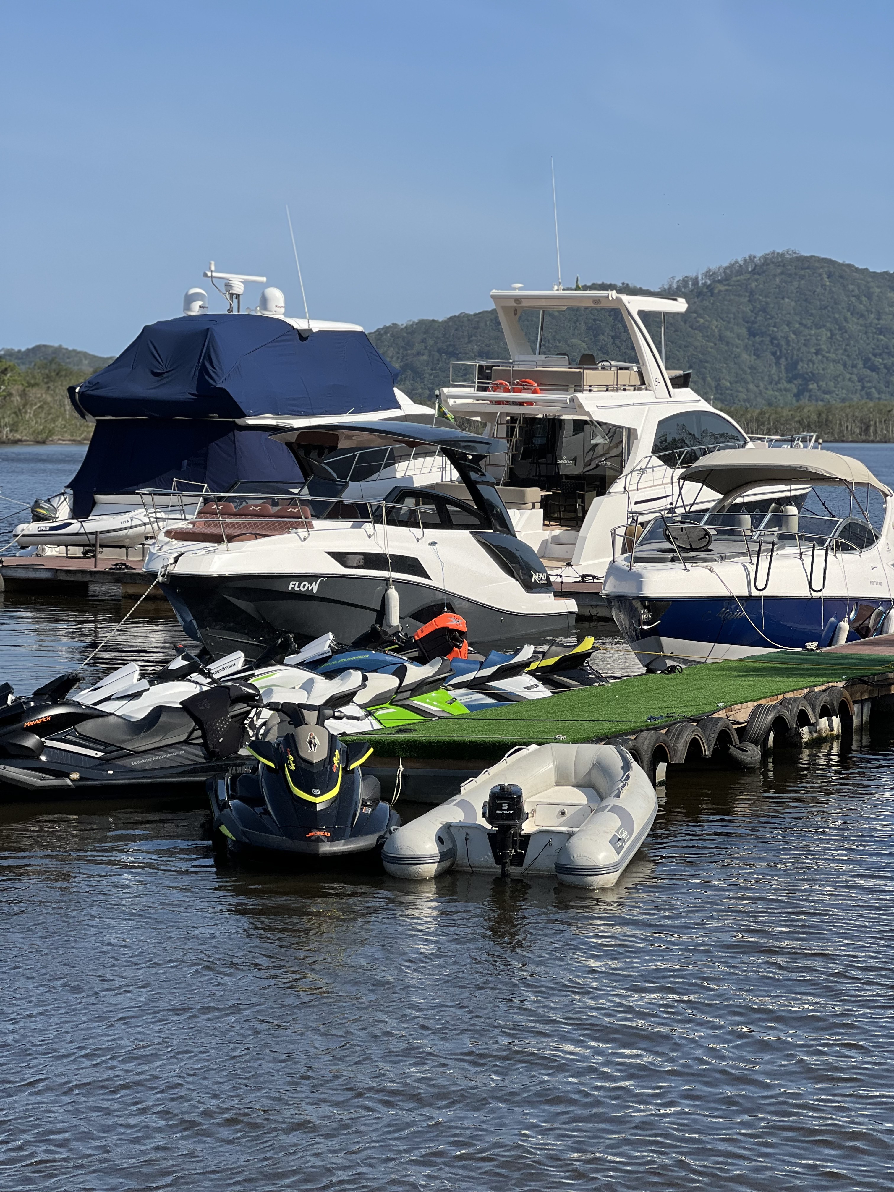 Lanchas e jet skis amarrados nos píeres do Pier Club